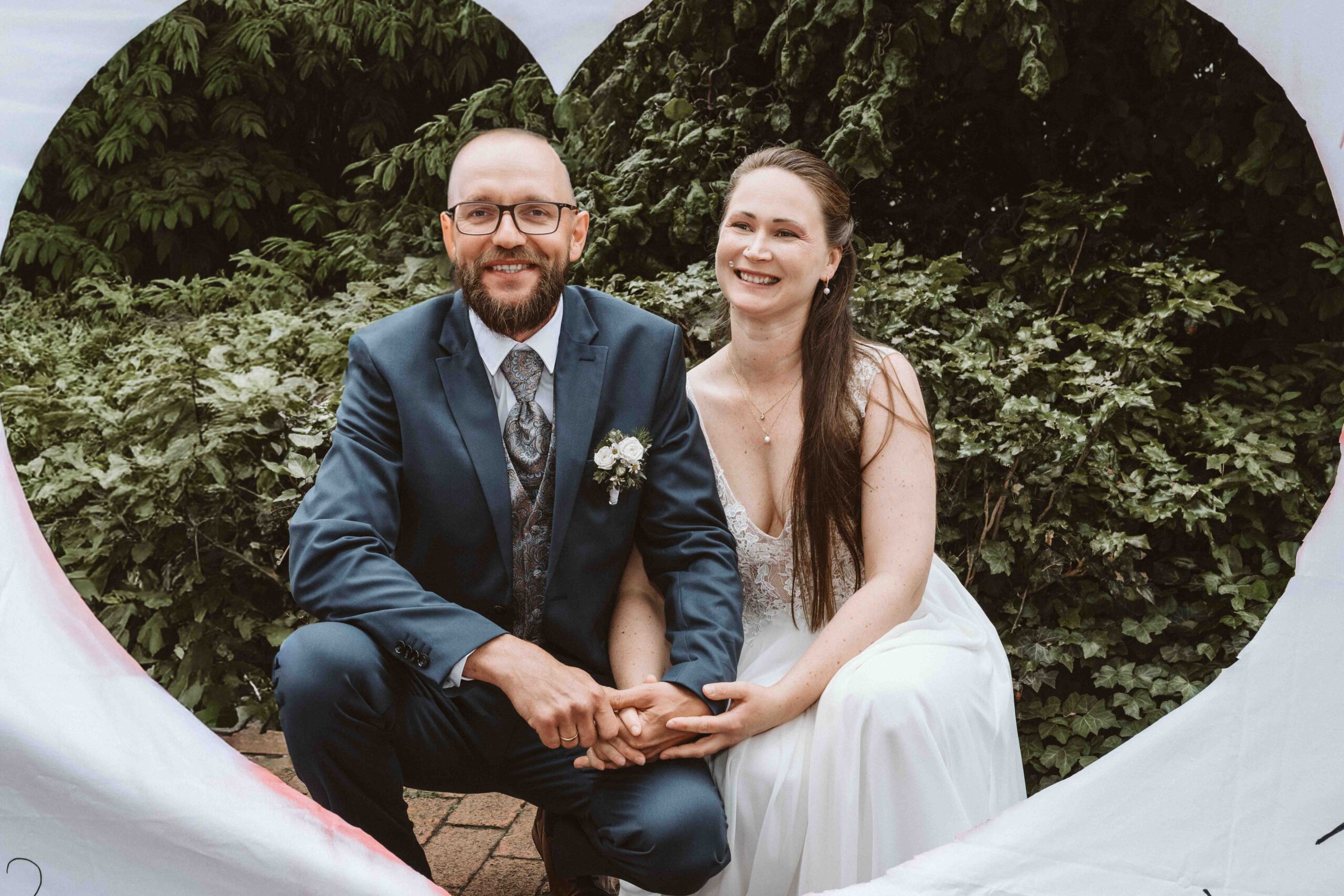 Brautpaar hinter dem ausgeschnittenen Herz